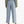 Person wearing light blue jeans and a patterned sweater on a white background