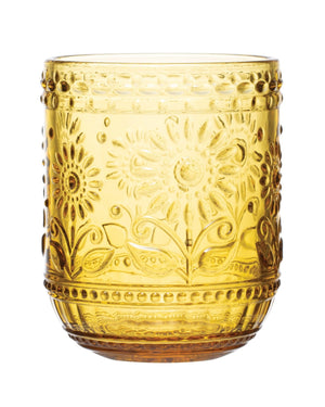 A round amber-colored embossed drinking glass with floral patterns.