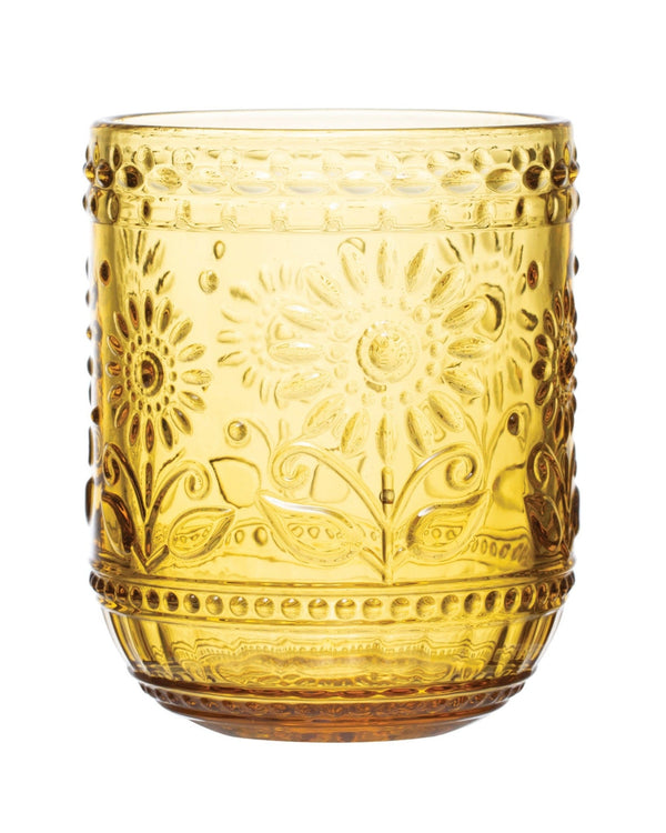 A round amber-colored embossed drinking glass with floral patterns.