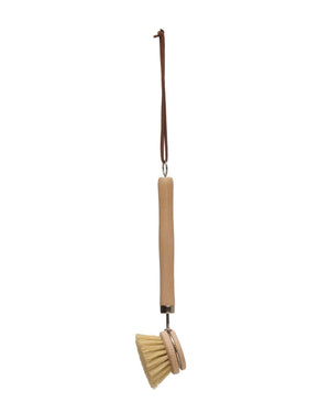 Beech wood dish brush with long leather strap on with background.