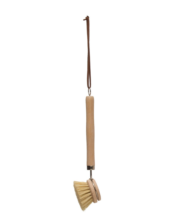 Beech wood dish brush with long leather strap on with background.